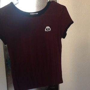 A maroon shirt with little panda on it